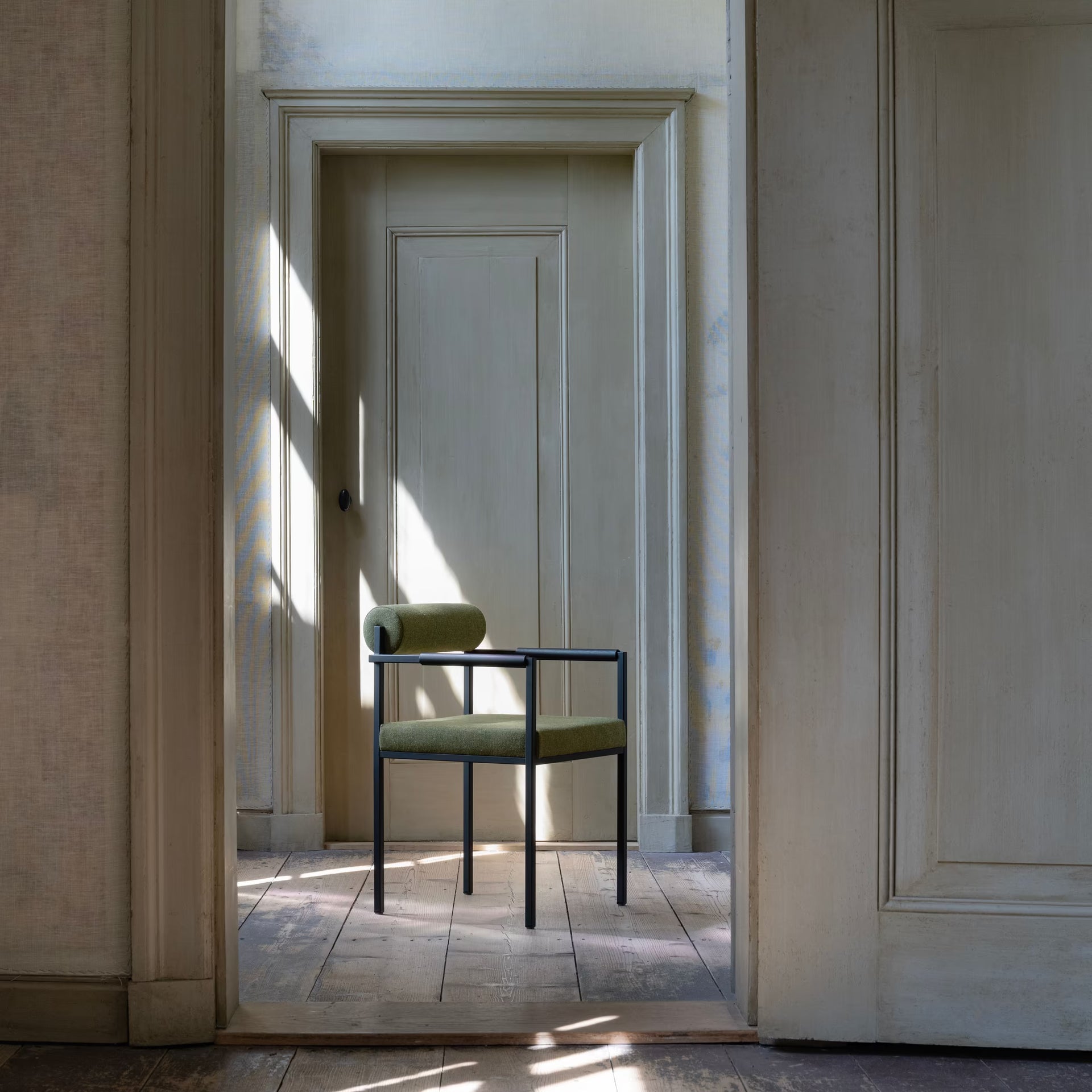 Bolster dining chair with armrest