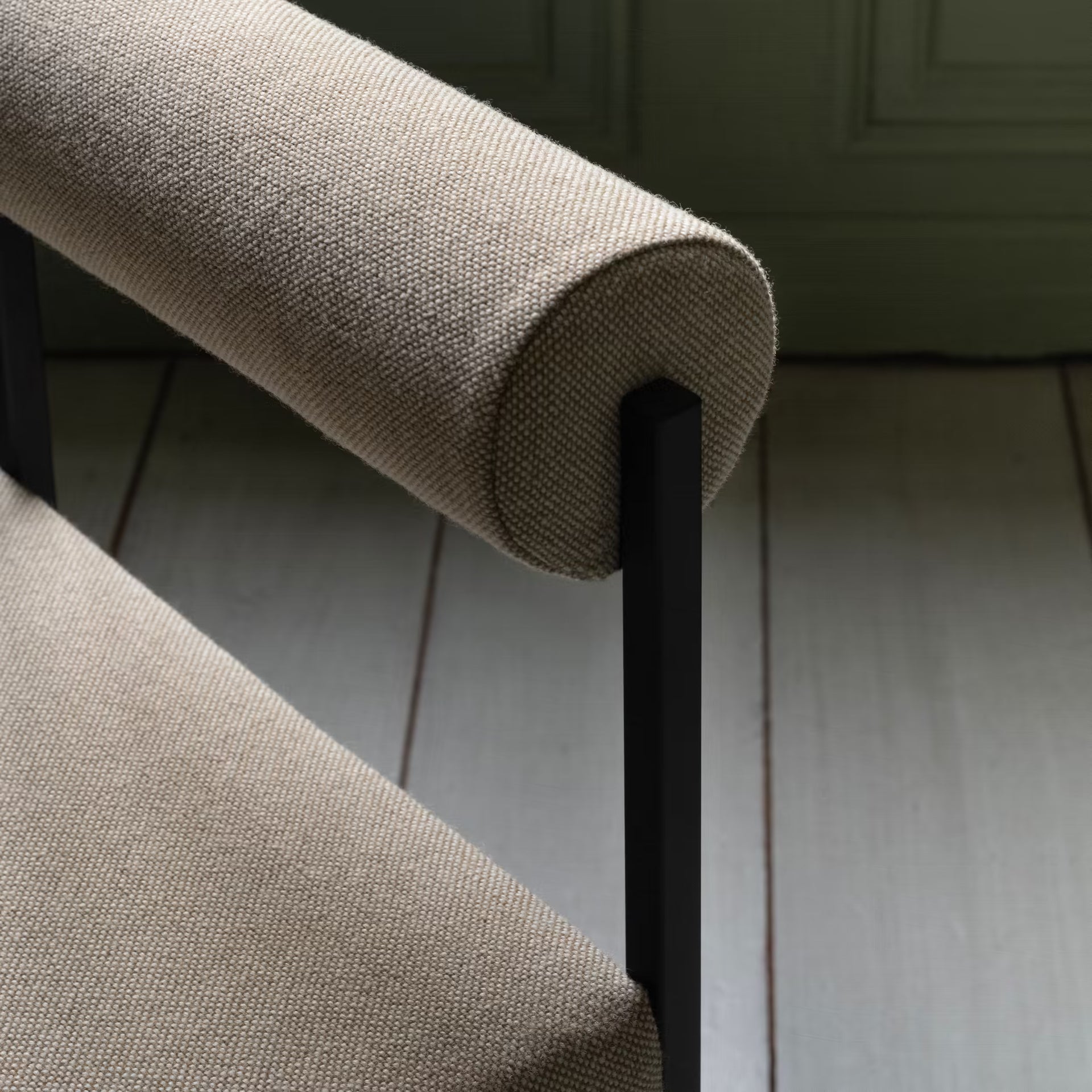 Bolster dining chair with armrest